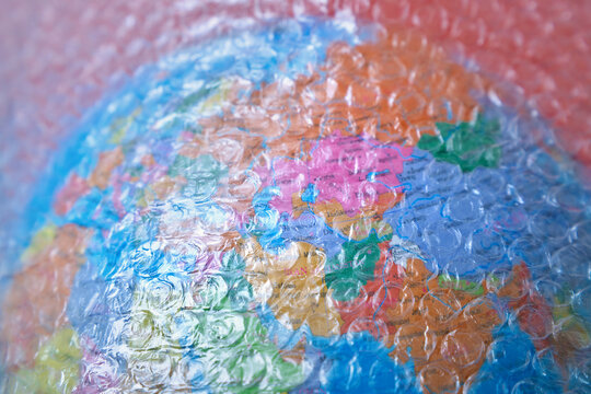 Colorful globe wrapped in clear bubble pack plastic