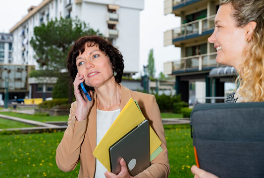 Business women collaborating outdoors in modern urban district