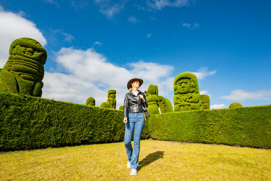 Tourist exploring Tulcan's famous cemetery topiaries