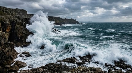 Fototapeta premium Ocean waves crashing against rugged cliffs under dramatic cloudy sky on stormy day at rocky coastal shoreline.