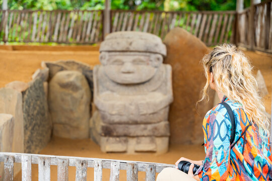 Tourist viewing stone statue at San Agustin Park