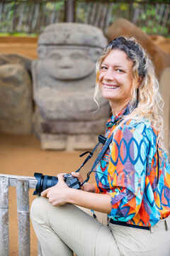 Traveler photographing stone statue at San Agustin Park