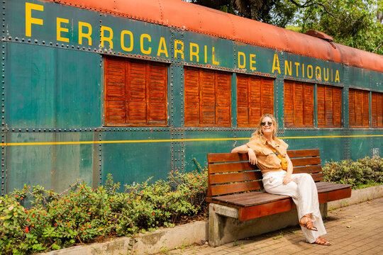 Solo traveler relaxing by old Medellin train car