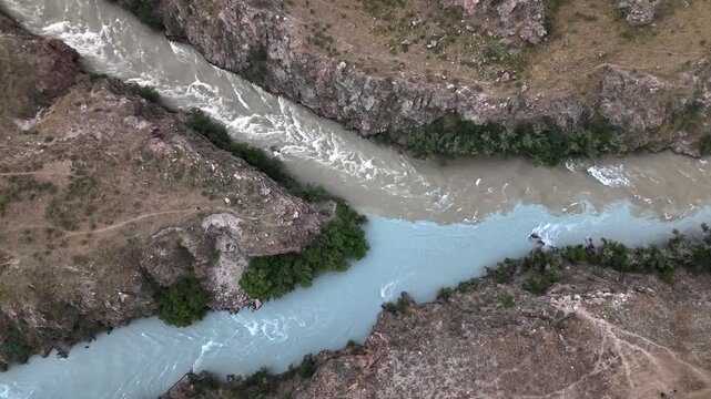 Wide aerial of Chu River gorge with dramatic rocky cliffs and rapids, Kyrgyzstan