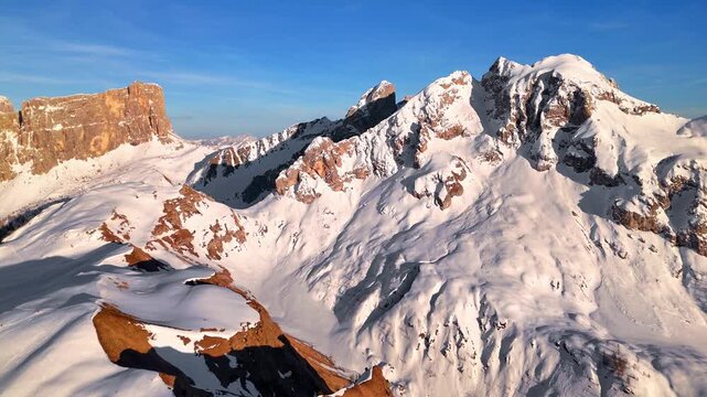 Aerial panorama of Lastoni di Formin toward Forcella Giau with snow-covered ridges, Dolomites