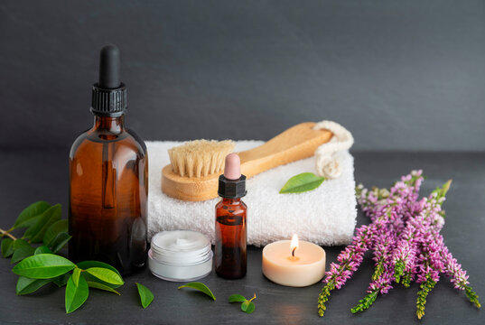 Spa skincare still life with essence oils, towel and flower