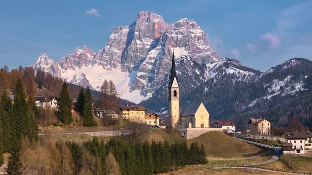 Aerial tracking toward church of Santa Fosca with Monte Pelmo towering behind, Dolomites