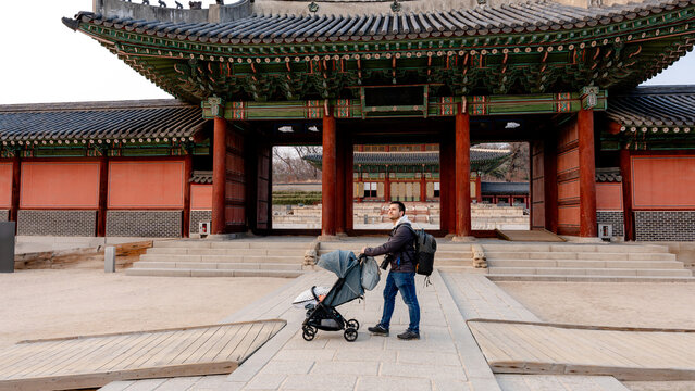Tourist with stroller at historic Changdeokgung Palace