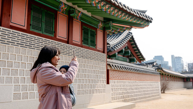 Woman photographing Gyeongbokgung Palace in Seoul
