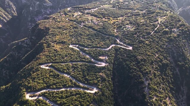 Winding road through deep mountain gorge with river below, Tzoumerka, Epirus, Greece