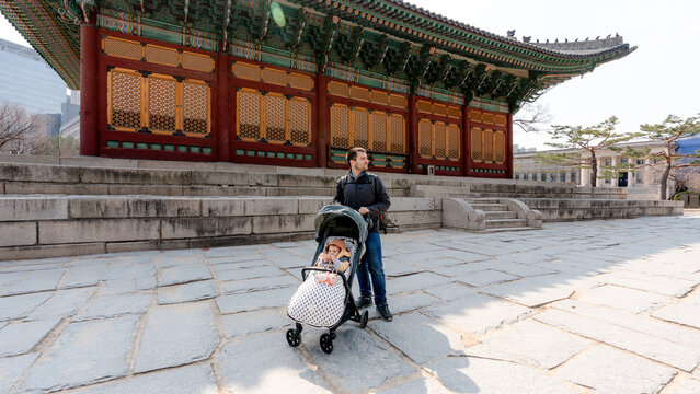 Father with stroller at Deoksugung Palace courtyard, Seoul