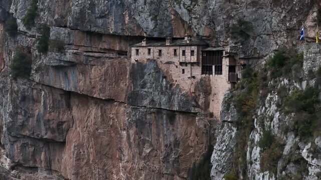 Close view of wooden structures built into sheer cliff at Kipina Monastery, Tzoumerka, Greece
