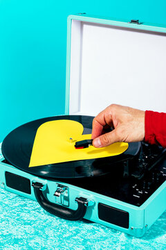 Retro vinyl record player with heart shaped sleeve and hand