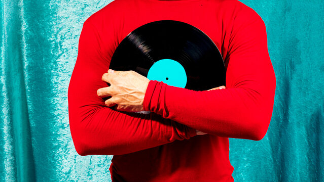 Person holding vinyl record for retro music concept