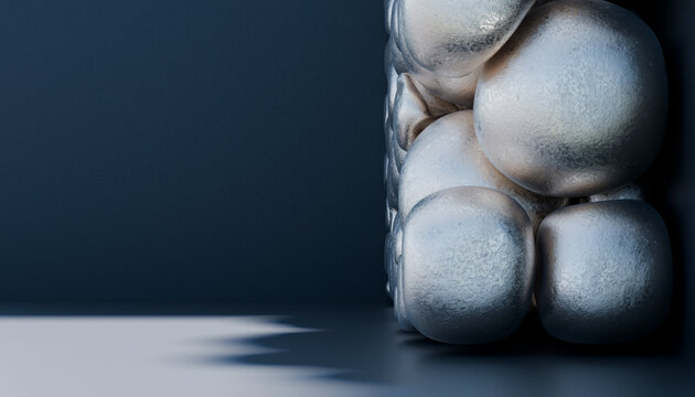 Close-up of silver balls stacked in cube on dark background