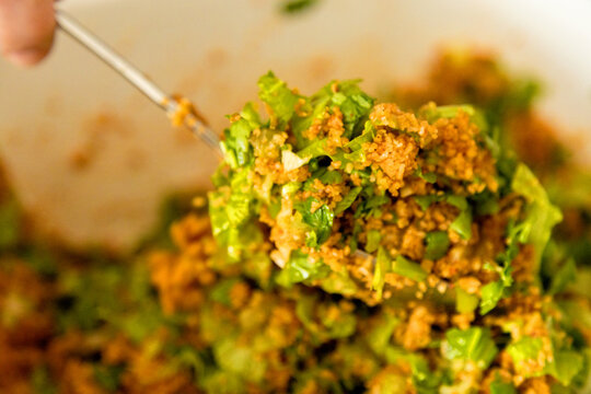 Closeup of bulgur vegetable salad being served with spoon