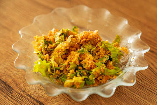 Bulgur salad with fresh vegetable and herb in glass bowl