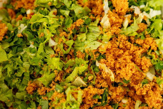 Closeup of bulgur salad with chopped vegetables and herb
