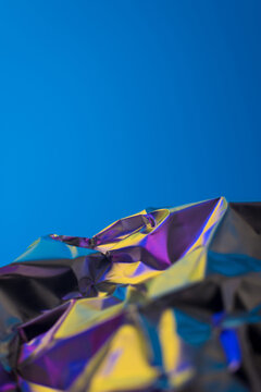 Abstract vibrant background with crumpled foil texture