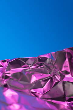 Metallic pink foil against vibrant clear background