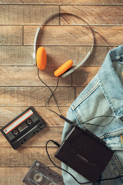 Retro walkman cassette player with orange headphones flat lay