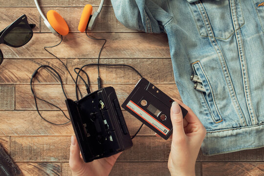 Retro walkman cassette player with orange headphones flatlay