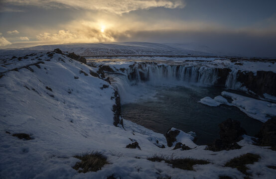 Winter sunset over Godafoss waterfall in northern Iceland