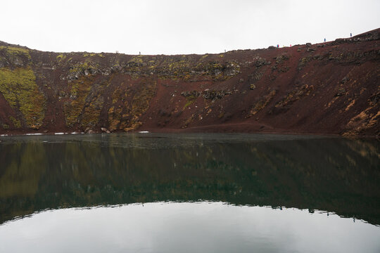 Volcanic crater lake with calm reflection in Iceland