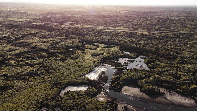 Aerial view of mossy lava fields and streams in Iceland