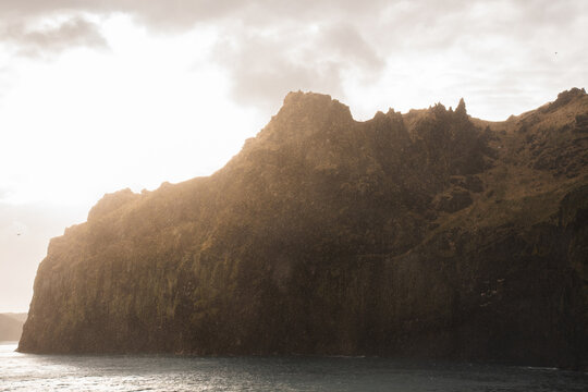 Sea cliff landscape at sunset in Westman Islands, Iceland