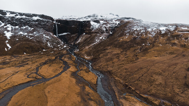 Moody icelandic waterfall and braided river in winter