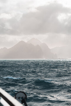 Stormy Atlantic sea and misty cliffs in Iceland