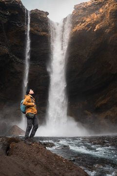 Man admiring Kvernufoss waterfall in Iceland canyon