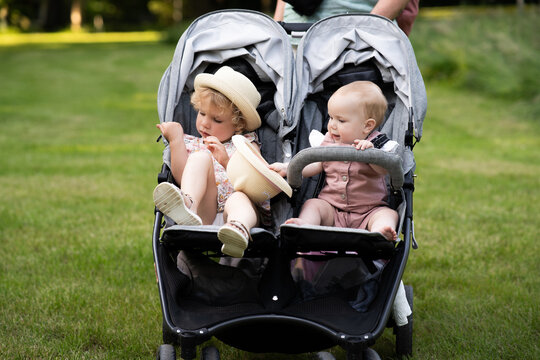 Happy family summer stroll with toddler and baby girl