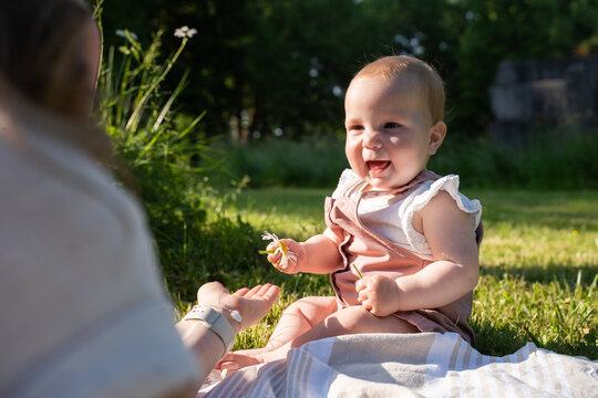 Happy family summer time with laughing baby girl outdoors