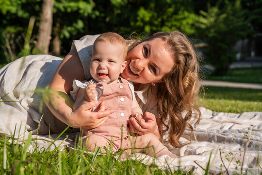 Happy mother and baby girl enjoying summer family time