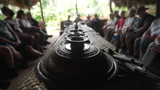 View of tourists (out of focus) and traditional curry pots in Hiriwadunna Village near Dambulla, Matale District, Sri Lanka, Asia