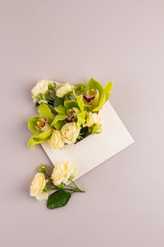 Floral envelope mockup with roses and orchid on beige