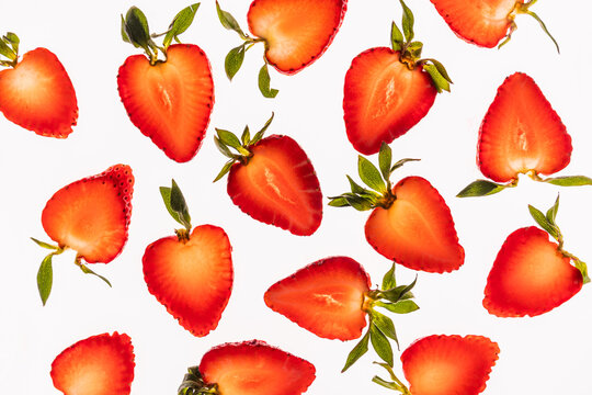 Strawberry halves pattern on white background, fresh fruit