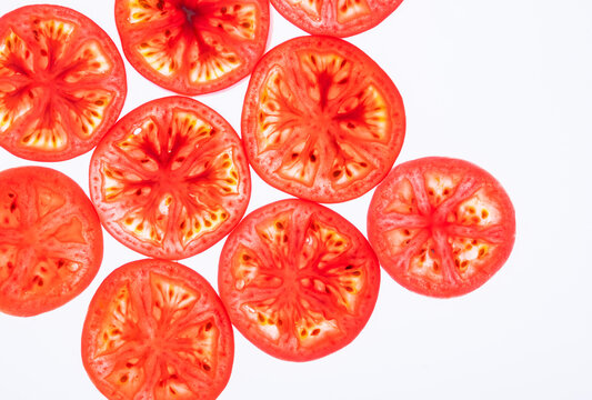 Sliced tomato pattern isolated on white background, top view