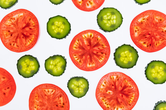 Seamless pattern of tomato and cucumber slices on white