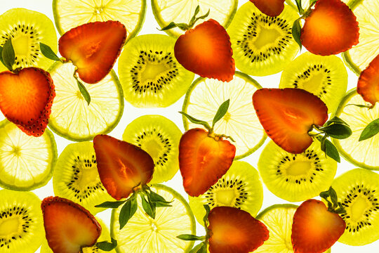 Fresh citrus and berry slices background on white