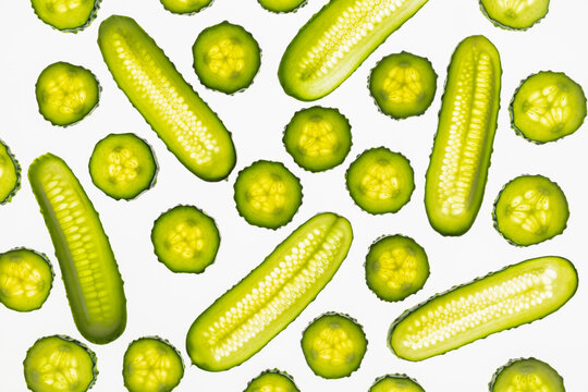 Fresh cucumber pattern with sliced rounds on white background