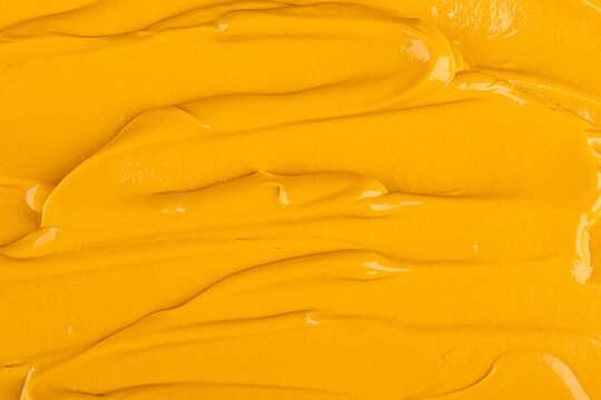 Smooth mango mousse dessert texture background in closeup