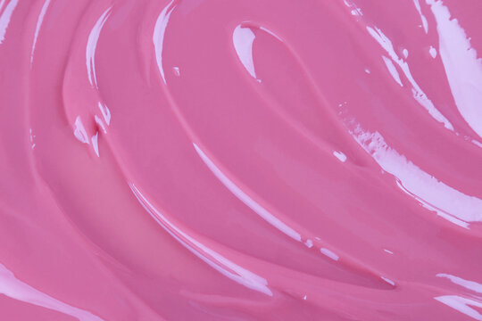 Creamy strawberry mousse texture background in glossy pink