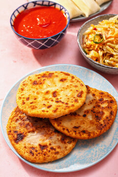 Top view tablescape of Latin American dishes on pink table