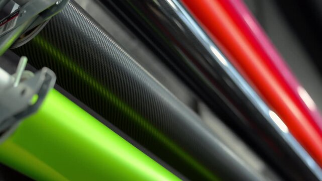Close up view of Professional automotive wrap shop with film installation equipment for applying protective and colored vinyl wrap on vehicles.