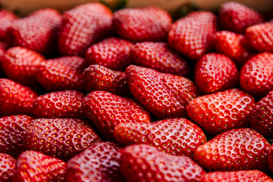 Close-up of ripe strawberries in a market crate texture