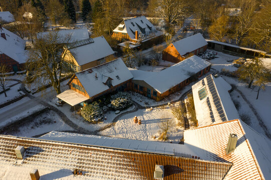 Snowy rural Germany village rooftops captured by drone