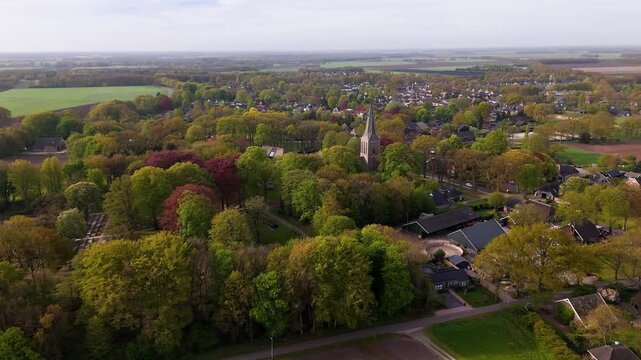 Aerial view of a small dutch village church surrounded by trees